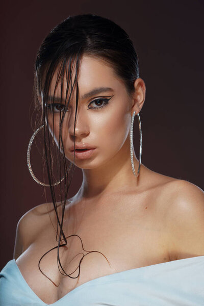 portrait of beautiful woman with blue eyes and golden makeup