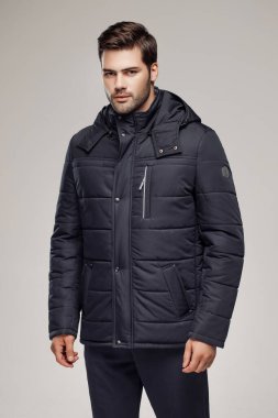 Moda stüdyosunda Avrupalı modelin şık, koyu renk ceketli fotoğrafı.  