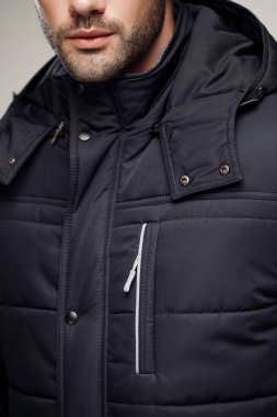 Stüdyoda havalı kıyafetler giyen manken adamın kırpılmış görüntüsü. 