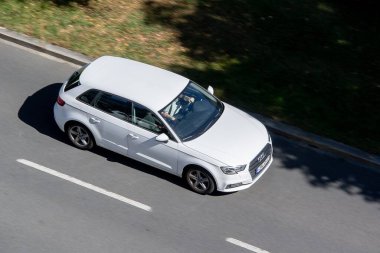 OSTRAVA, CZECHIA - JUNE 6, 2024: White Audi A3 (8V) Sportback hatchback car with motion blur effect clipart