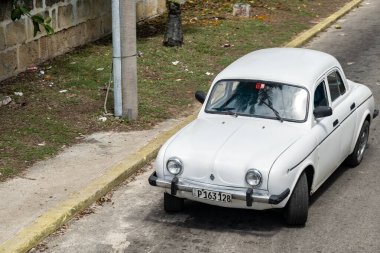 VARADERO, CUBA - AUGUST 30, 2023: Vintage Renault Dauphine French sedan car in streets of Cuba clipart