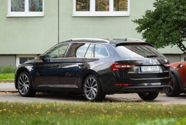 OSTRAVA, CZECH REPUBLIC - SEPTEMBER 22, 2023: Skoda Superb Combi executive estate car parked on street, rear view clipart