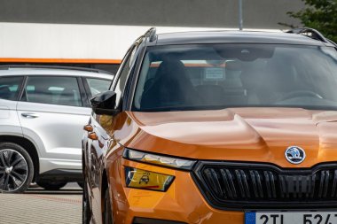 HAVIROV, CZECH REPUBLIC - OCTOBER 6, 2023: Detail of orange Skoda Kamiq compact crossover presented at dealership clipart