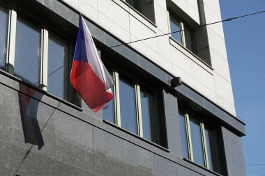 Czech national flag waving on modern building, shadow on marble wall clipart