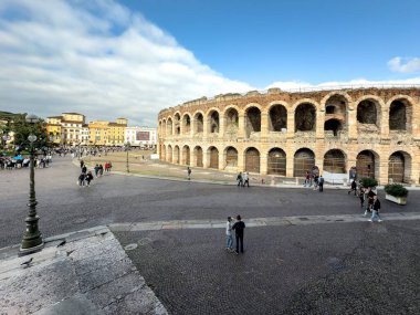 VERONA, ITALY - OCTOBER 27, 2024: Wide angle view of Arena di Verona round building from Palazzo Barbieri in Verona, Italy clipart