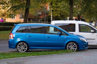 OSTRAVA, CZECHIA - OCTOBER 17, 2023: Blue Opel Zafira B OPC sports MPV car parked on street clipart