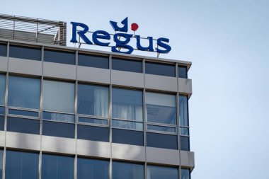 OSTRAVA, CZECHIA - SEPTEMBER 28, 2023: Banner of Regus company providing virtual offices on modern building clipart