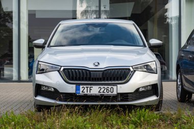 OSTRAVA, CZECH REPUBLIC - OCTOBER 6, 2023: Brand new silver Skoda Scala car outside dealership presenting car, frontal view clipart