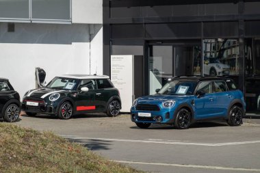 OSTRAVA, CZECHIA - SEPTEMBER 28, 2023: Mini Cooper S F66 and Countryman II F60 vehicle presented at dealership clipart