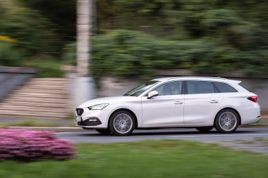 HAVIROV, CZECHIA - SEPTEMBER 28, 2023: Seat Leon IV ST estate car with motion blur effect clipart