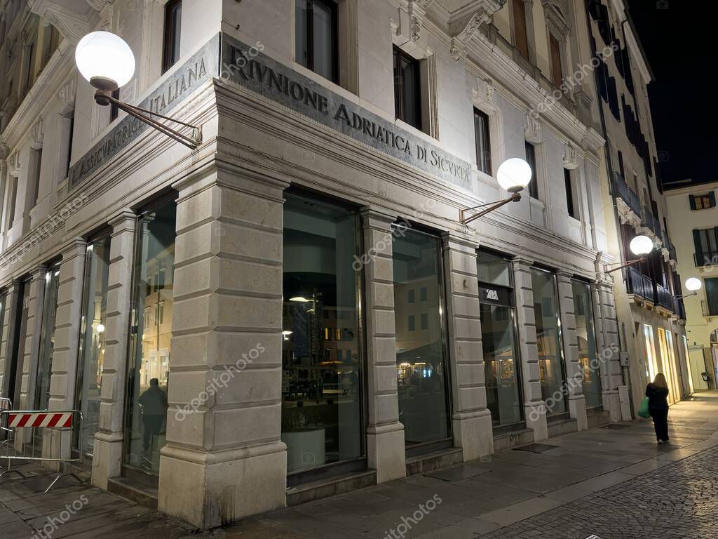PADOVA, ITALY - OCTOBER 30, 2024: Branch of Riunione Adriatica di Sicurta bank office in Padova, Italy at night