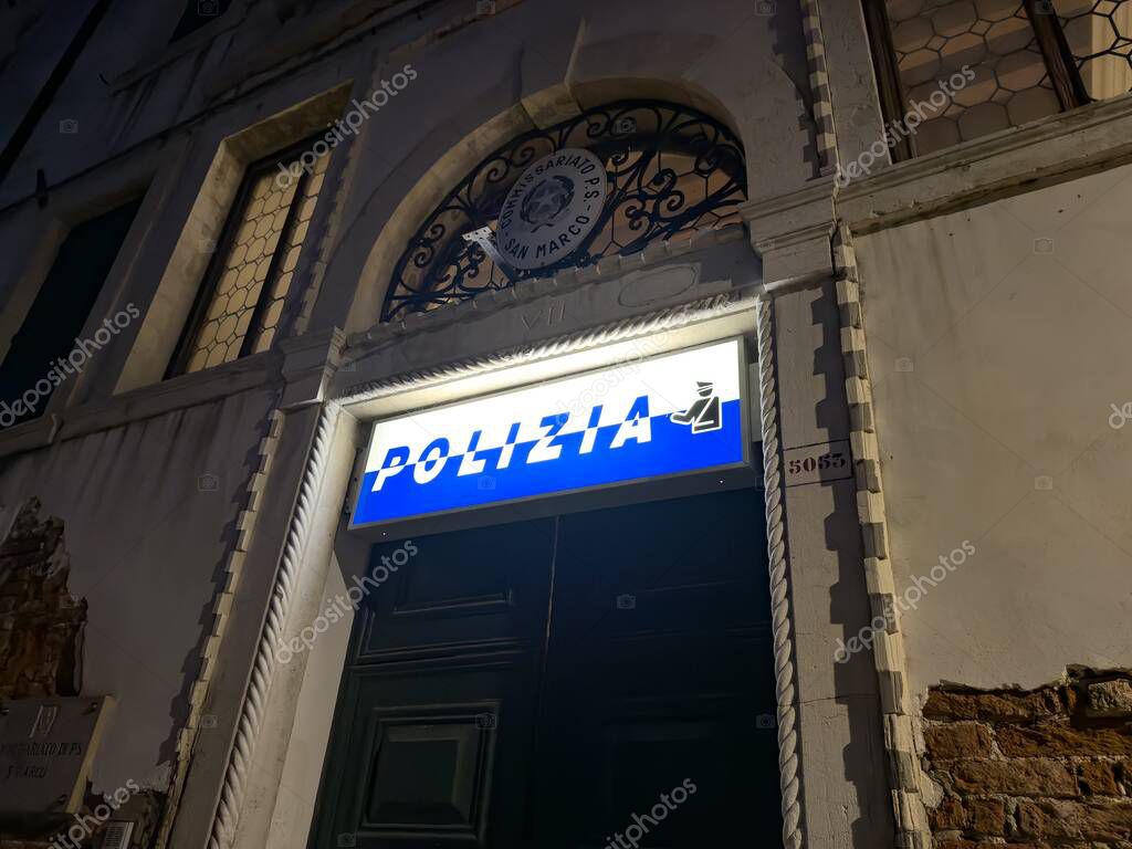 VENICE, ITALY - NOVEMBER 1, 2024: Polizia sign abone the entrace to police office in Venice, Italy at night