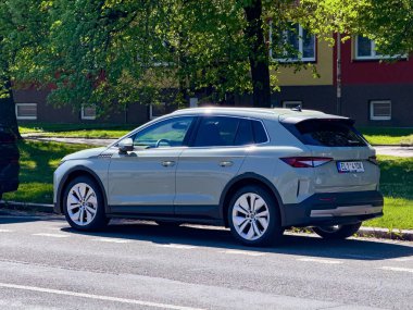Ostrava, Çek Cumhuriyeti - 27 Nisan 2025: Yeşil elektrikli Skoda Elroq kompakt SUV arabası caddeye park edilmiş, arka manzara
