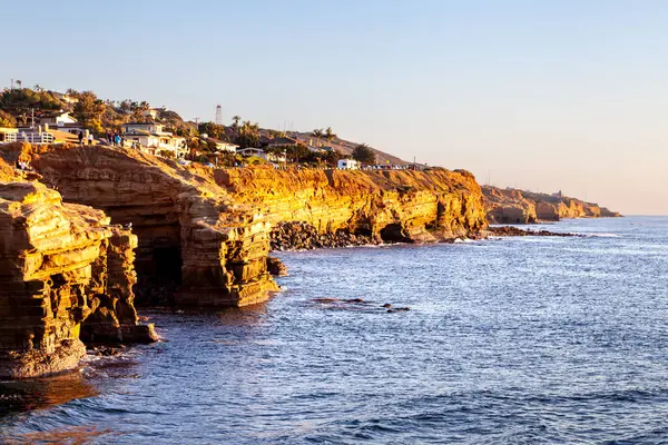 Sahildeki görkemli kıyı şeridi gün batımının altın parıltısıyla canlanıyor. San Diego, Kaliforniya 'daki Sunset Cliffs' de sanatsal güzellikler gözler önüne seriliyor.