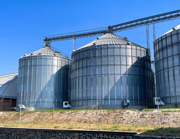 Modern granaries covered with metal sheet and equipped for crop preservation