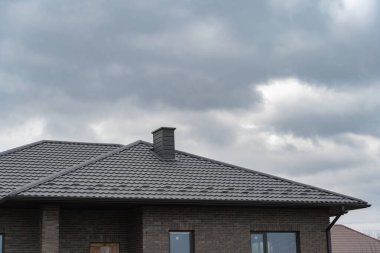 Kış manzarasına karşı modern bir bacası olan ev.