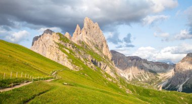 panoramic view of Seceda mountain peak with hiking trial, Dolomites, Italy clipart