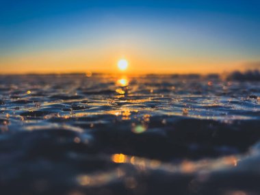 Frosty air and frozen lake surface in a beautiful sunset landscape. Beautiful ice shapes and sunlight. Photo from Sotkamo, Finland. clipart