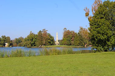 View to Mosque in nature area with lake and blue sky.  clipart