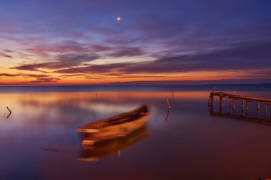 sunrise with boats on the lake in the Danube Delta 2 clipart