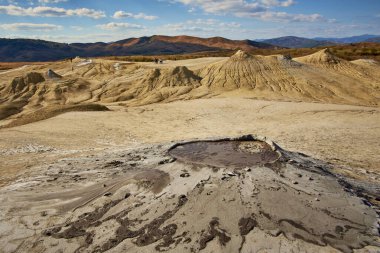 cones of mud volcanoes from which rivers of mud flow clipart