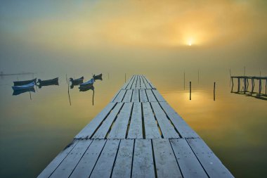 fishing boats on the lake in the fog clipart