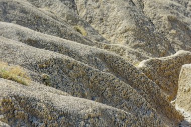 cones of mud volcanoes from which rivers of mud flow clipart