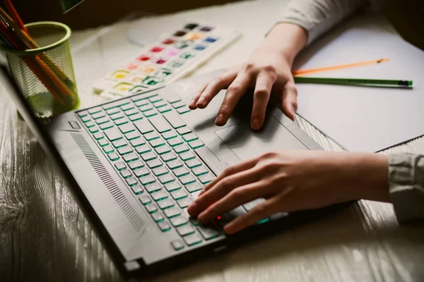 stock image Hands on the laptop keyboard. A teenager enters text by pressing the keys of a black laptop. Communication in social networks.