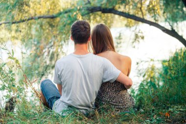 Birkaç genç kız ve erkek el ele tutuşuyorlar. Adam kızı seviyor. Genç aşıklar gölün kıyısında, ağacın yanında oturuyor..