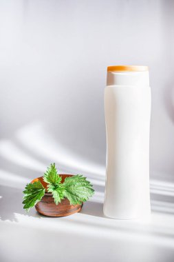 Natural spa,herbal cosmetics. Medicinal herb for beauty. Nettle grass that strengthens the hair roots and cares for the scalp. Fresh nettle leaves