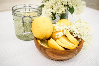 Canned drink with elderberry and lemon. A refreshing summer drink with fresh elderberry flowers.