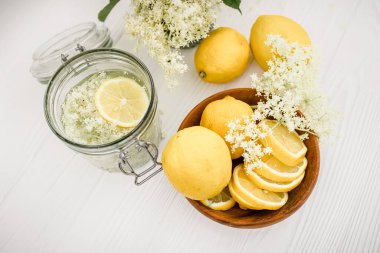 Canned drink with elderberry and lemon. A refreshing summer drink with fresh elderberry flowers.