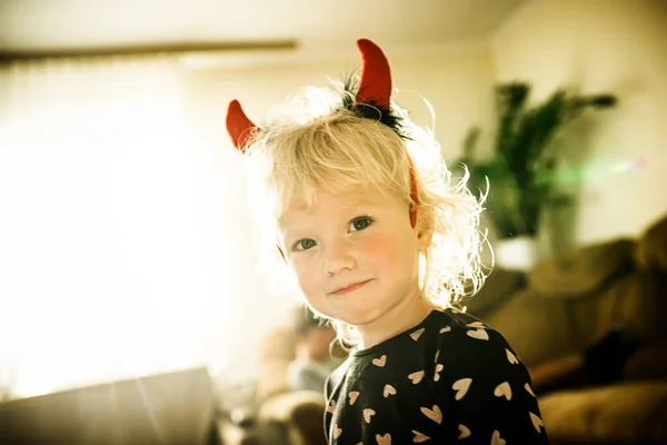 Horns of mischief: this little devil is all set for Halloween fun.