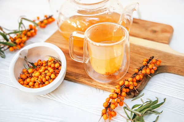 Sea buckthorn tea in a glass teapot, capturing the essence of natures bounty.