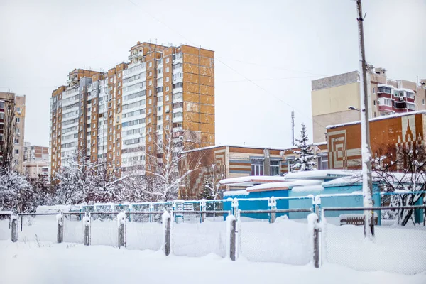 City landscape in winter. Snow-covered houses and streets of the city