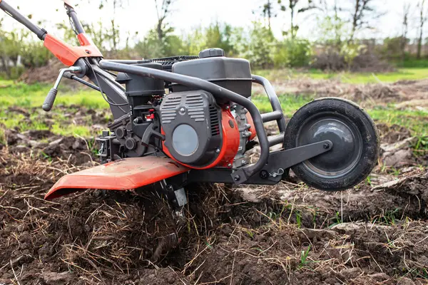 Cutting-edge agricultural technology at play: the tiller meticulously tills the untouched soil, setting the stage for abundant harvests