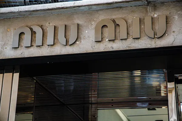 stock image Venecia, Italia, 17 of August 2024: A stylish boutique Miu Miu storefront features a sleek and modern exterior with metallic signage in a bustling urban area, illuminated by daylight.