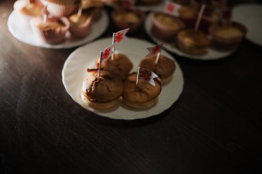 Tabağında canlı bayraklar olan küçük tatlı çeşitleri akşam kutlaması sırasında bir aile toplantısında neşeli bir atmosfer yaratıyor..