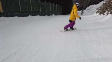 Snowboardcular Alplerin tozlu yamaçlarının tadını çıkarıyorlar.
