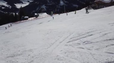 Snowboardcular Alplerin tozlu yamaçlarının tadını çıkarıyorlar.