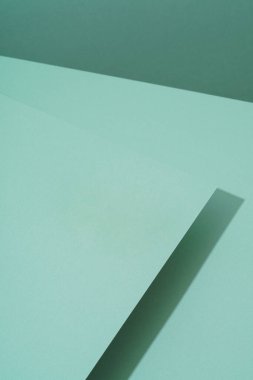 Gölgeli yeşil kağıdın renkli arkaplanı. Soyut geometrik