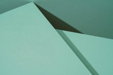 Gölgeli yeşil kağıdın renkli arkaplanı. Soyut geometrik