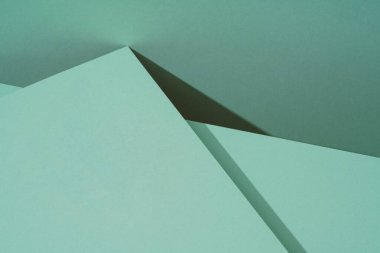 Gölgeli yeşil kağıdın renkli arkaplanı. Soyut geometrik