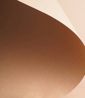 Kahverengi kağıttan gölgeli renkli bir arka plan. Soyut geometrik