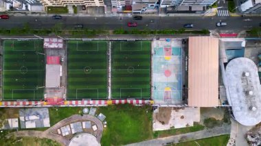 Güneşli bir öğleden sonra insansız hava aracından görülen küçük futbol ve basketbol sahaları.