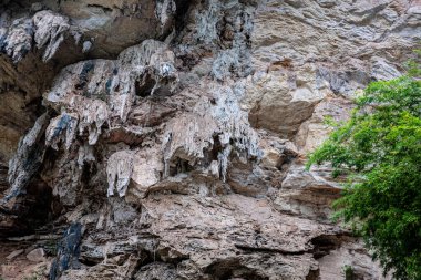 Buddhist cave temple close up stone walls southeast asia photo clipart