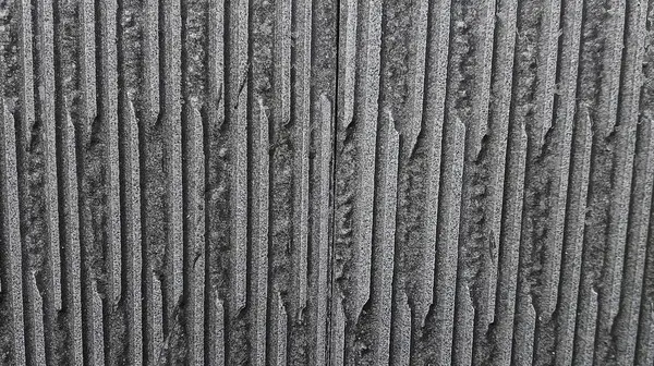 Çinko 'nun soyut dokusu, tekrar eden yatay dalgalı desenli kaba bir görüntüdür. Yüzey metalden yapılmış gibi görünüyor, bir vida görünür. Endüstriyel ve dengesiz..