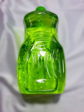 Green cleaning fluid on a gray background