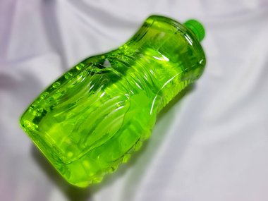 Green cleaning fluid on a gray background