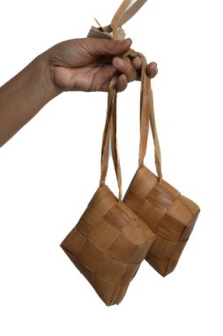 Beyaz arka planda el ele tutuşan ketupat ya da pirinç köftesi